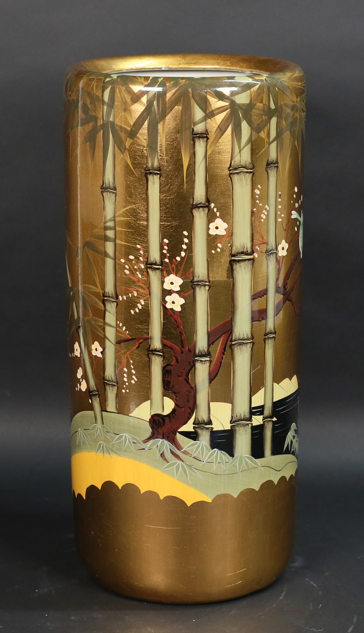 Chinese Porcelain Umbrella Stand: Chinese porcelain umbrella stand. Gilt ground with hand painted decoration of bamboo, birds and cherry blossoms. 17 1/2"H x 7 5/8"-diameter. Minor scratches.
