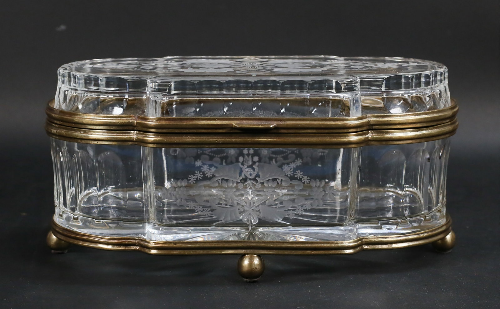 Castilian Crystal Jewel Casket: Castilian Polish lead crystal jewel casket / dresser box. Castilian Poland label to the underside. Etched decoration of flowers, brass mounts. Minor scratches and losses to brass patina. 12 7/8"L x 6"