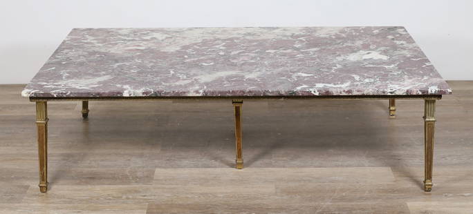 Louis XVI Style Marble Top Cocktail Table: Louis XVI style marble top cocktail table. 20th century. Rose and white colored marble sitting atop plywood with brass border and colonnade legs. Small chips and losses to edges of marble. Scratches t