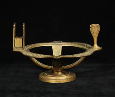 Tiffany Studios Etruscan Match Stand: Tiffany Studios gilt bronze match stand, in the Etruscan pattern. With match book holder and pipe tamper / snuffer. Center bowl missing. Stamped on the underside of the rim Tiffany Studios New York 20