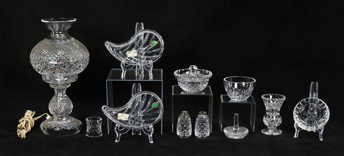 11 Pieces Waterford Crystal: 11 pieces signed Waterford. Lamp with hurricane shade, pair of leaf dishes in original boxes, pair of salt and pepper shakers (no tops), napkin ring, small vase, ashtray, ring tree, small bowl, bowl,
