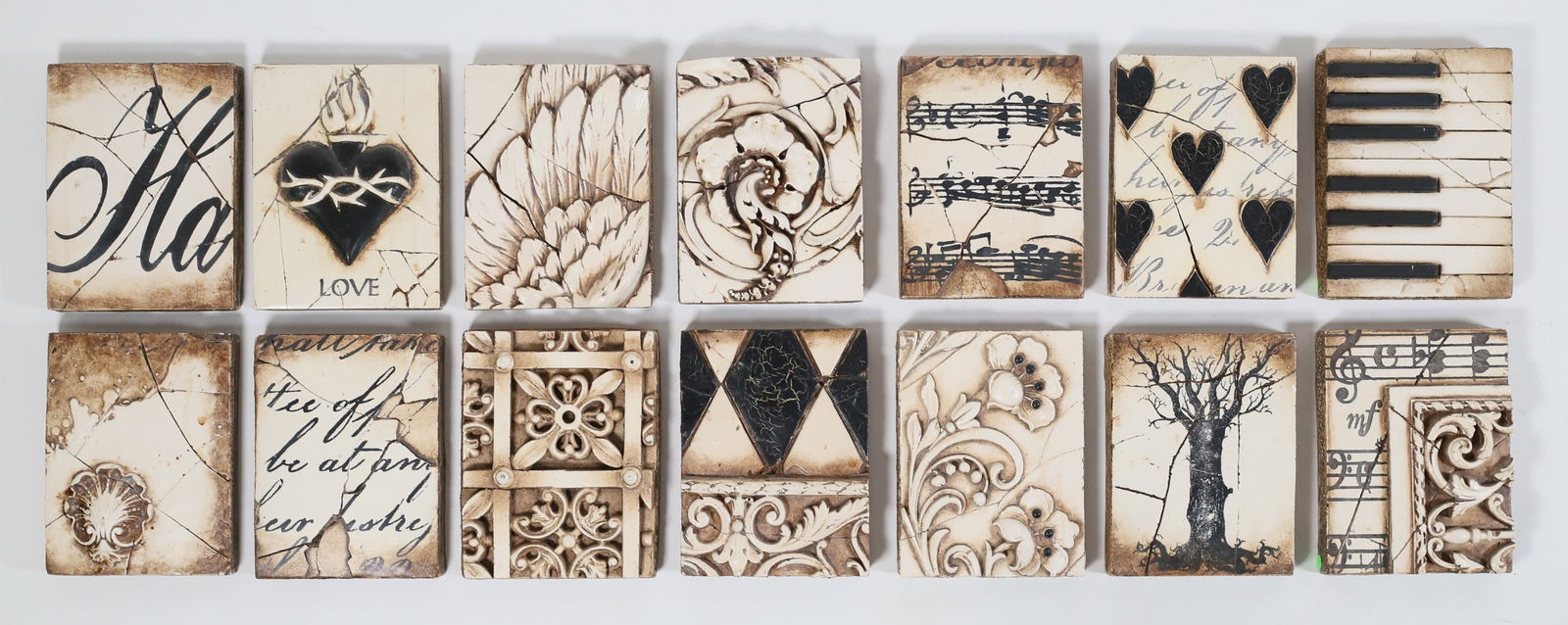 14 Sid Dickens Memory Blocks: 14 Sid Dickens Memory Block wood and plaster tiles / wall plaques. Designs including music, piano keys, foliate motifs. Each 8" x 6" x 1 1/4"D. Most with losses to black paint on the reverse, two with