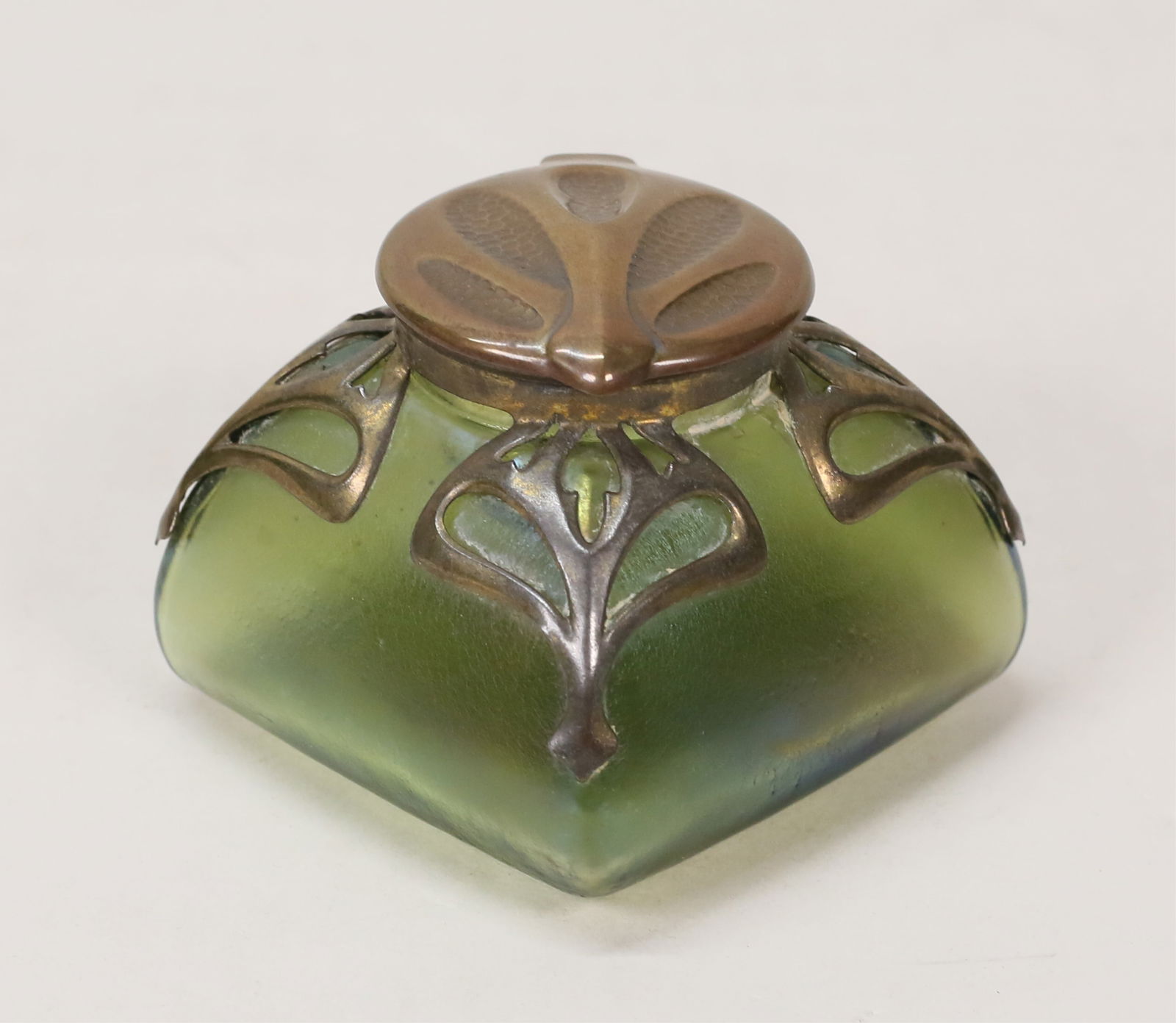 Loetz Style Art Noueavu Art Glass Inkwell: Loetz / Kralik style art nouveau art glass inkwell. Iridescent glass, patinated metal mounts. Unsigned. 2 3/4"H. Chips to rim of glass insert, losses to patina on mounts.