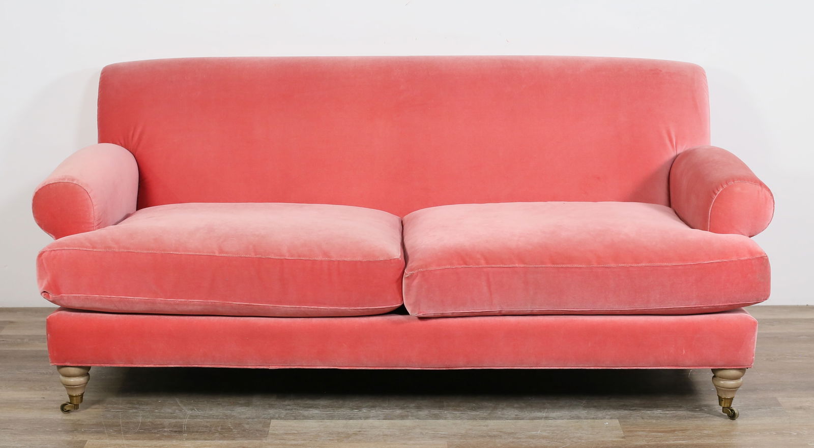 Anthropologie Freestyle Collection Sofa: "Freestyle Collection" sofa retailed by Anthropologie. 21st century. Two seater sofa with pink upholstery and front legs on casters. Freestyle Collection label on underside of cushions. Fading, scuffs