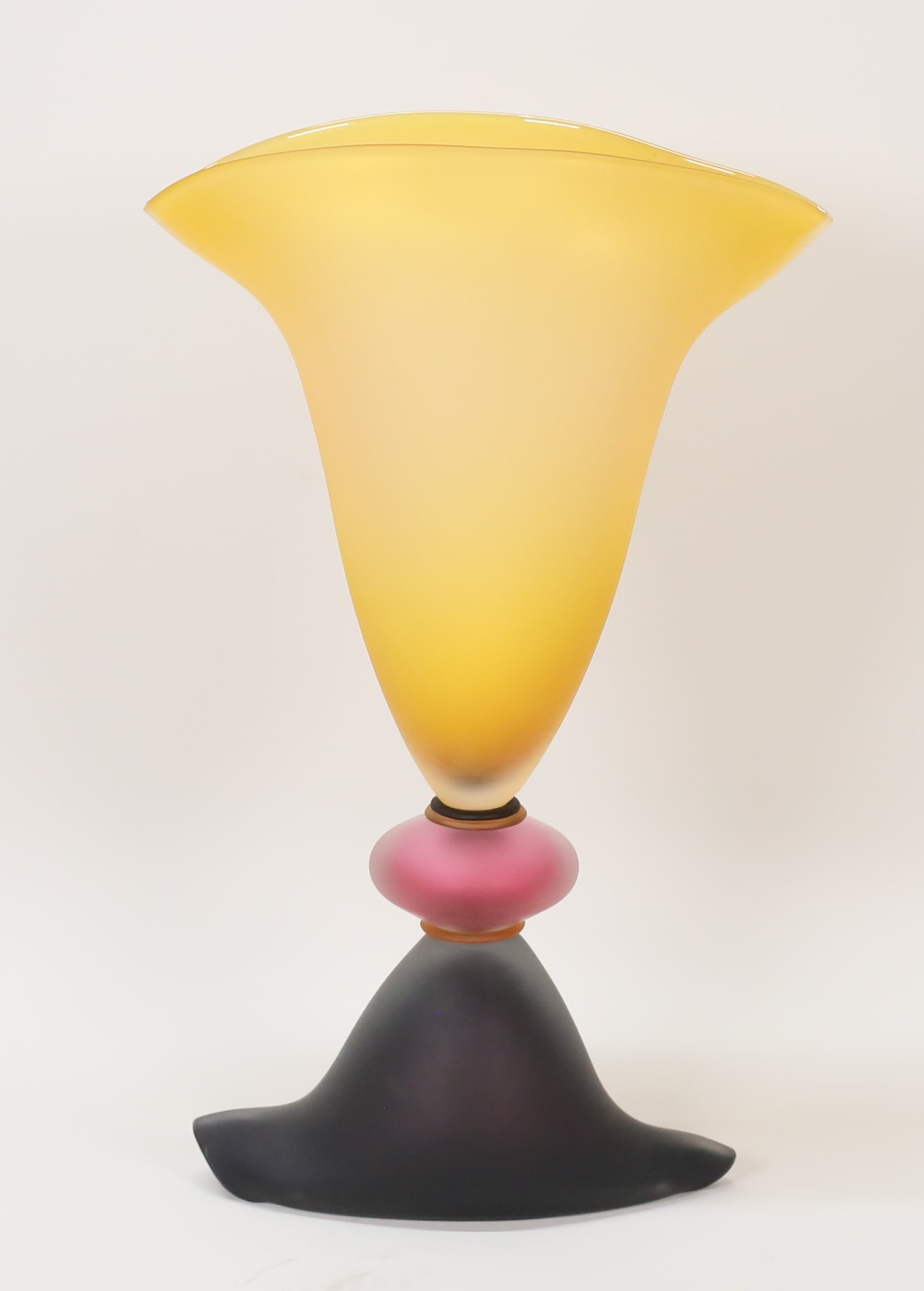 Stephan Cox Memphis Style Art Glass Vase: Stephan Cox (American, 1956-). Modern art glass vase. Memphis Milano style, frosted glass in yellow, pink, orange and purple. Signed and dated 97 on the base. 15 1/2"H.
