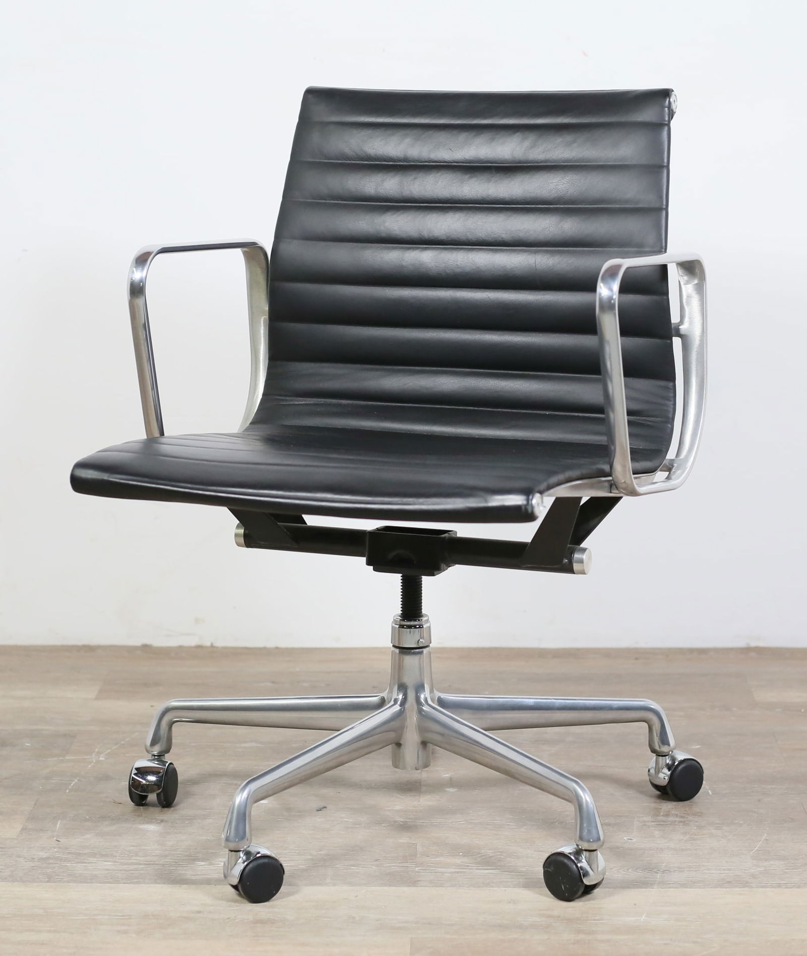 Eames for Herman Miller Aluminum Group Chair: Charles Eames (American, Missouri, 1907-1978) and Ray Eames (American, California, 1912-1988) for Herman Miller. Aluminum Group office chair. 21st century. Aluminum arms and frame supporting black lea