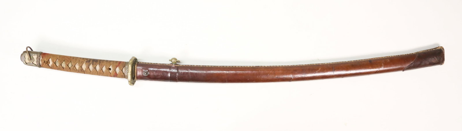 WWII Japanese Shin Gunto Style Katana Sword: WWII Japanese Shin Gunto style katana. Tang is unsigned. Some scattered wear from age, though blade is quite clean it has some nips on edge, some small spots of pitting and rust. Lock from scabbard to