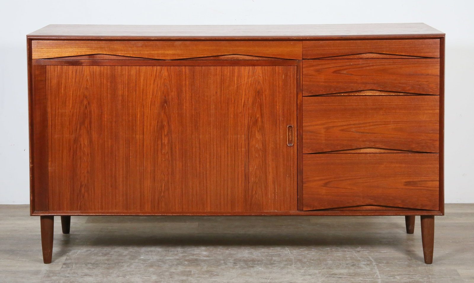 Arne Vodder Style Danish Modern Tambour Dresser: Danish Modern tambour door dresser in the style of Arne Vodder (Danish, 1926-2009). Mid 20th century. Teak, dowel legs, tambour door, eight total drawers. No apparent maker's marks or brand labels pre