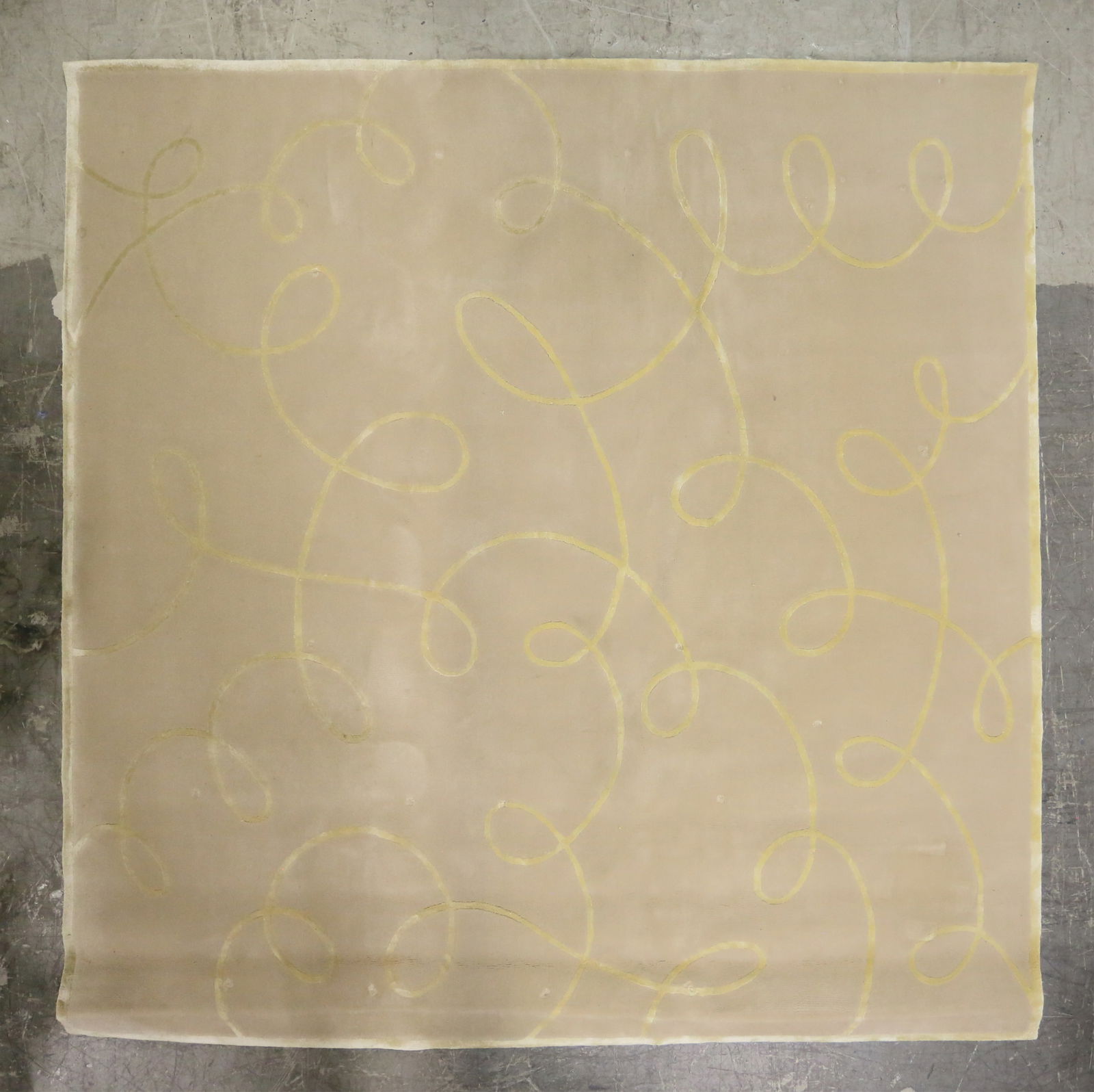 Edward Fields Contemporary Rug: Edward Fields contemporary rug. Gold spirals against beige field. Stamped "COPYRIGHT EDWARD FIELDS INC" and dated 3/2003 on back of rug. Serial number "17775" on back of rug. Indentations and wear thr