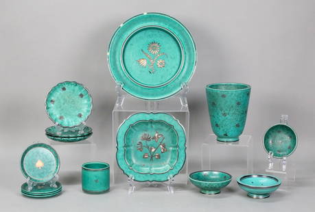 14 Pieces Gustavsberg Argenta Pottery: Wilhelm Kage for Gustavsberg, 14 piece Argenta Swedish pottery with silver overlay, various marks. Vase, 5"H; plate, 8 1/4"-diameter; dish / ashtray, 6 1/4"W; set of 3 ashtrays, each 4 1/4"-diameter;