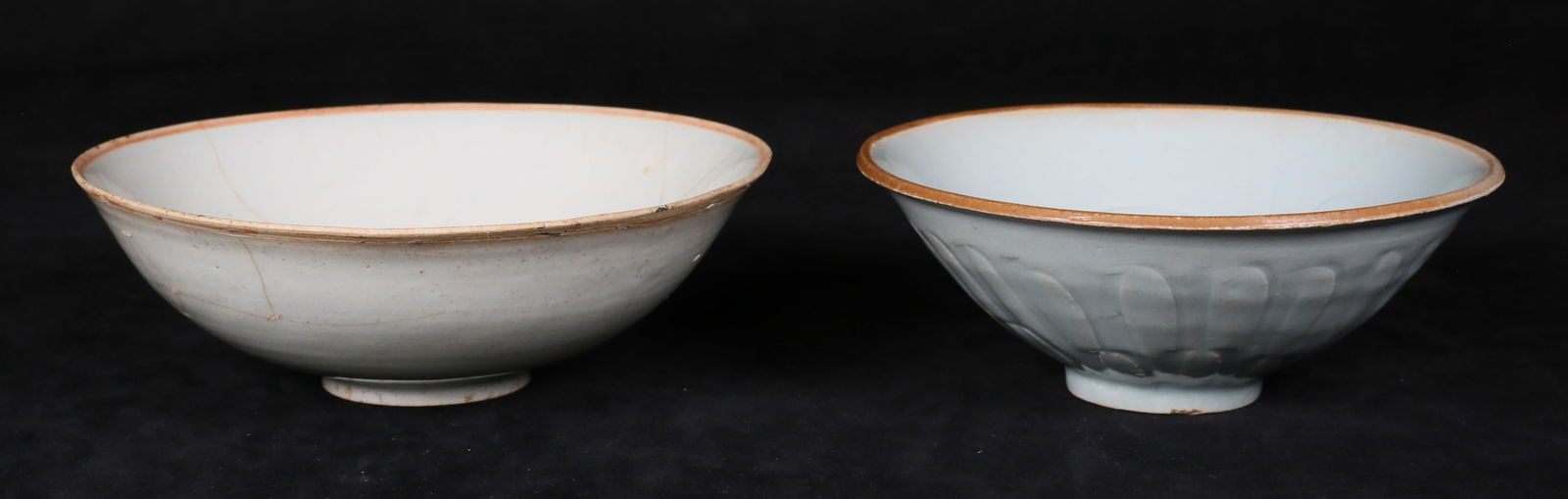 2 Chinese Celadon Bowls: Chinese celadon porcelain bowls. Both with incised floral decoration. Both unmarked. 2 1/2"H x 7 1/2"-diameter, and 2 3/4"H x 6 7/8"-diameter. Larger with extensive repairs throughout and chips to the