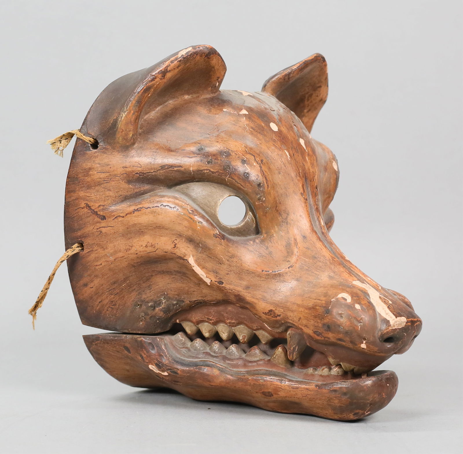 Japanese Fox Kyogen Mask: Japanese kitsune (fox) kyogen noh theater mask. Carved and painted wood, articulated mouth. 7 3/8"H x 7"L. Chips, cracks and paint loss throughout, fraying and breaks to string.