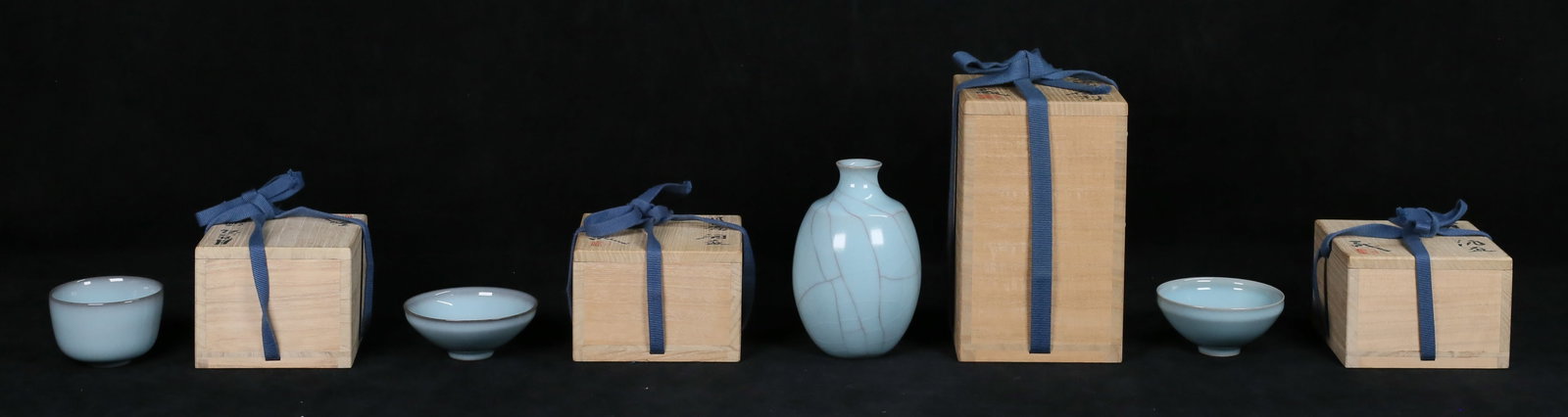 Suzuki Sansei 4 Pieces Japanese Pottery: Suzuki Sansei (Japanese, 1936-). 4 pieces Japanese pottery. Cup, 2"H x 2 7/8"-diameter; 2 guimoni, taller 1 5/8"H x 3 1/4"-diameter; celadon sake bottle, 5"H. All signed with artist's impressed mark a