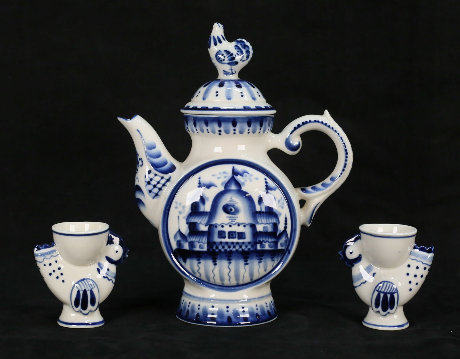 3 Pieces Russian Blue & White Porcelain: 3 pieces Russian blue and white porcelain. Gzhel teapot, 9 1/2"H; pair of egg cups marked hand painted USSR, each 3 1/4"H. Provenance: Estate of Princess Maria "Mimi" Romanoff.