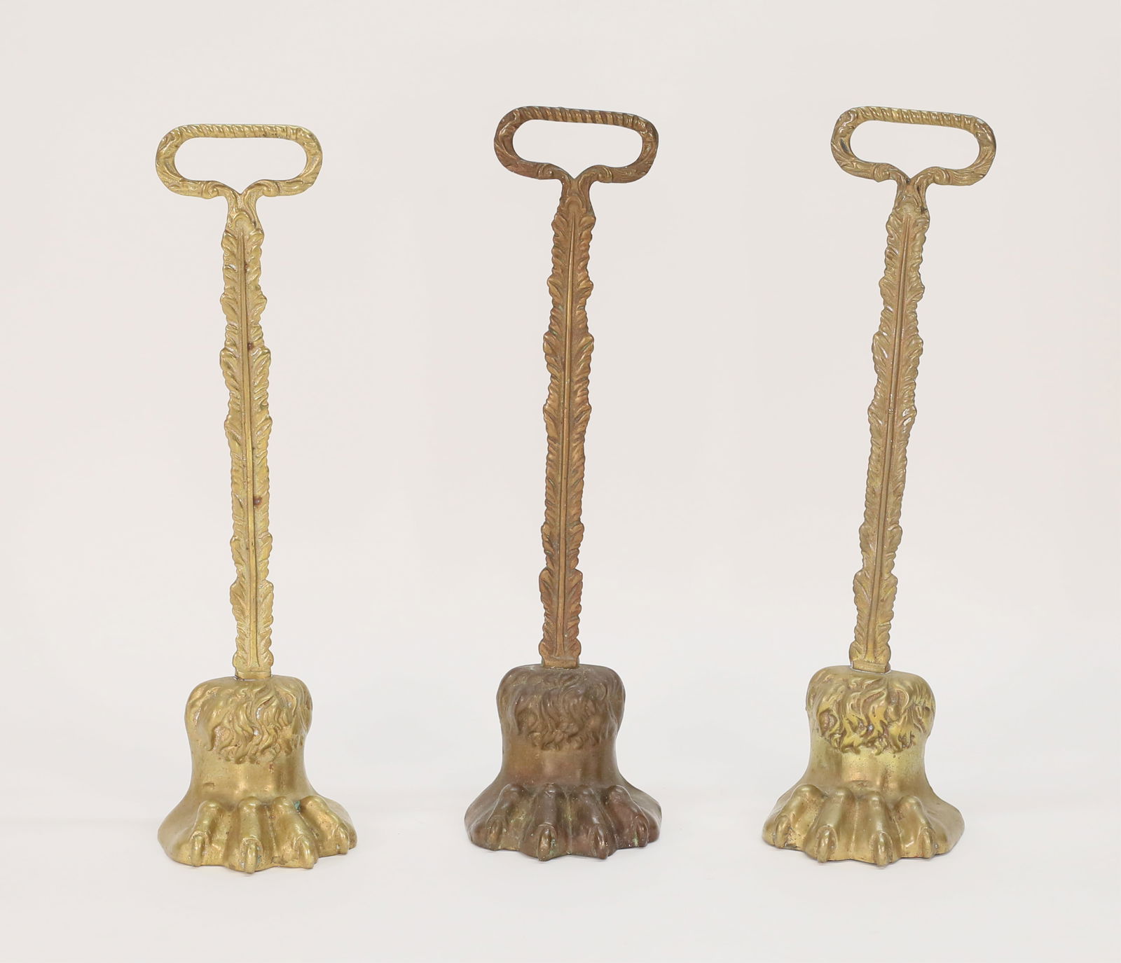 3 Brass Lion's Paw Doorstops: 3 brass lion's paw door stops. Each 14 5/8"H. Minor losses and wear to patina. Provenance: Seitz Family, Hartshorne House, NJ.
