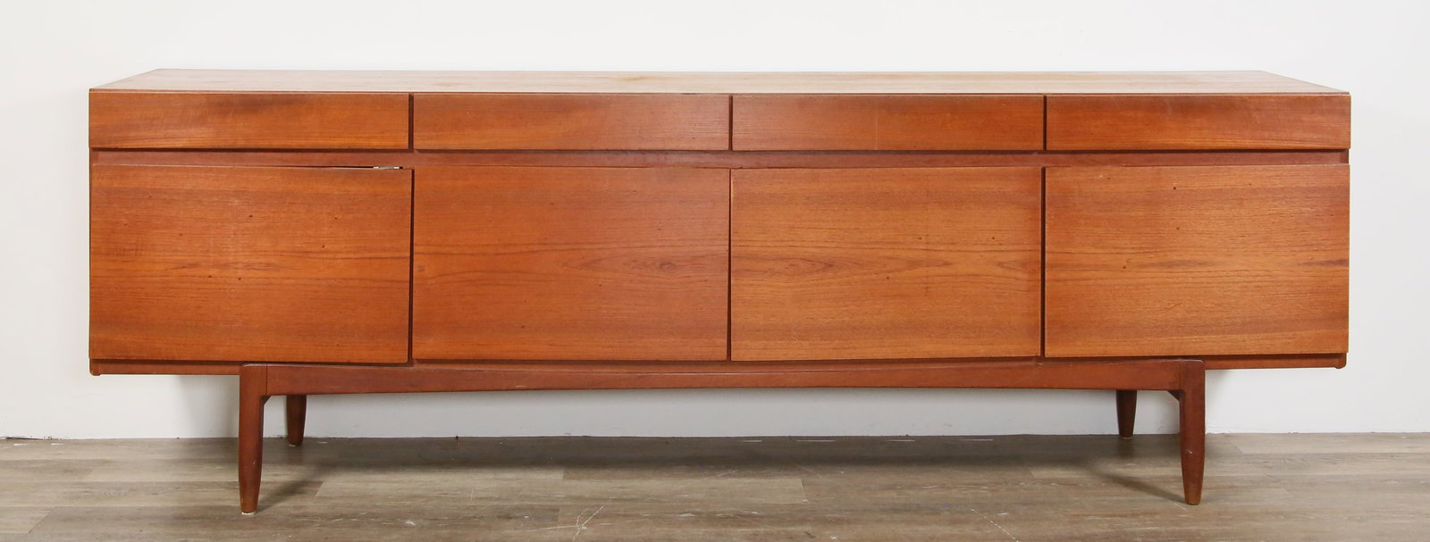 Ib Kofod-Larsen Danish Modern Sideboard: Ib Kofod-Larsen for Faarup Mobelfabrick, Denmark. Mid-century modern teak sideboard. 4 drawers and 4 doors, with lined drawers in one section of cabinet. Danish control tag interior of one drawer, oth