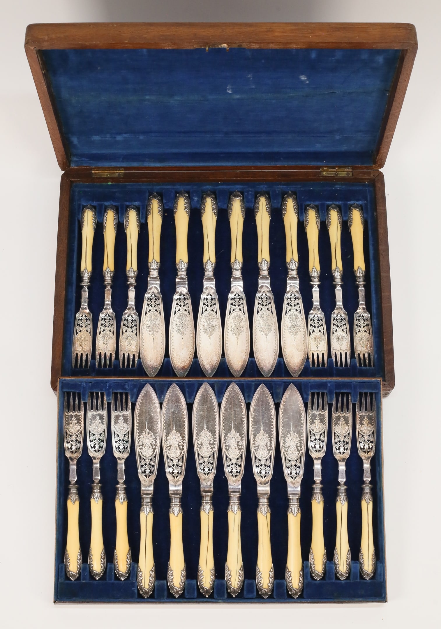 24 Piece Mappin & Webb Silverplate Fish Set: Mappin & Webb silverplate and bone fish set., service for 12. 24 pieces (12 knives, 12 forks), in a fitted wooden case. Knives 9 1/4"L, case 15 1/4" x 10 3/4" x 2 1/2". Splits and cracks to handles; c