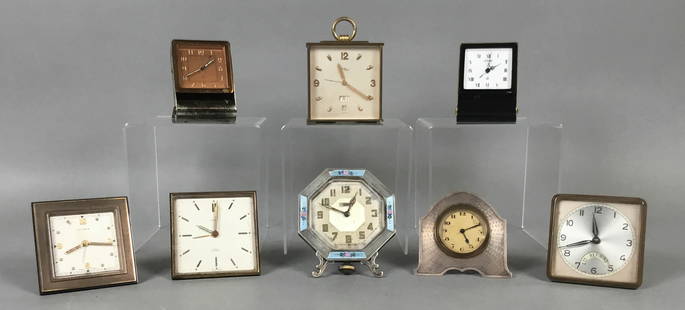 8 Travel & Desk Clocks LeCoultre, Gubelin, Elgin: 8 travel and desk clocks. Wickett Refining Company German clock, Gubelin, Cyma, Imhof, hallmarked English sterling, Elgin, and 2 LeCoultre travel clocks. Imhof 4 1/8"H, LeCoultre with Roman numerals 3