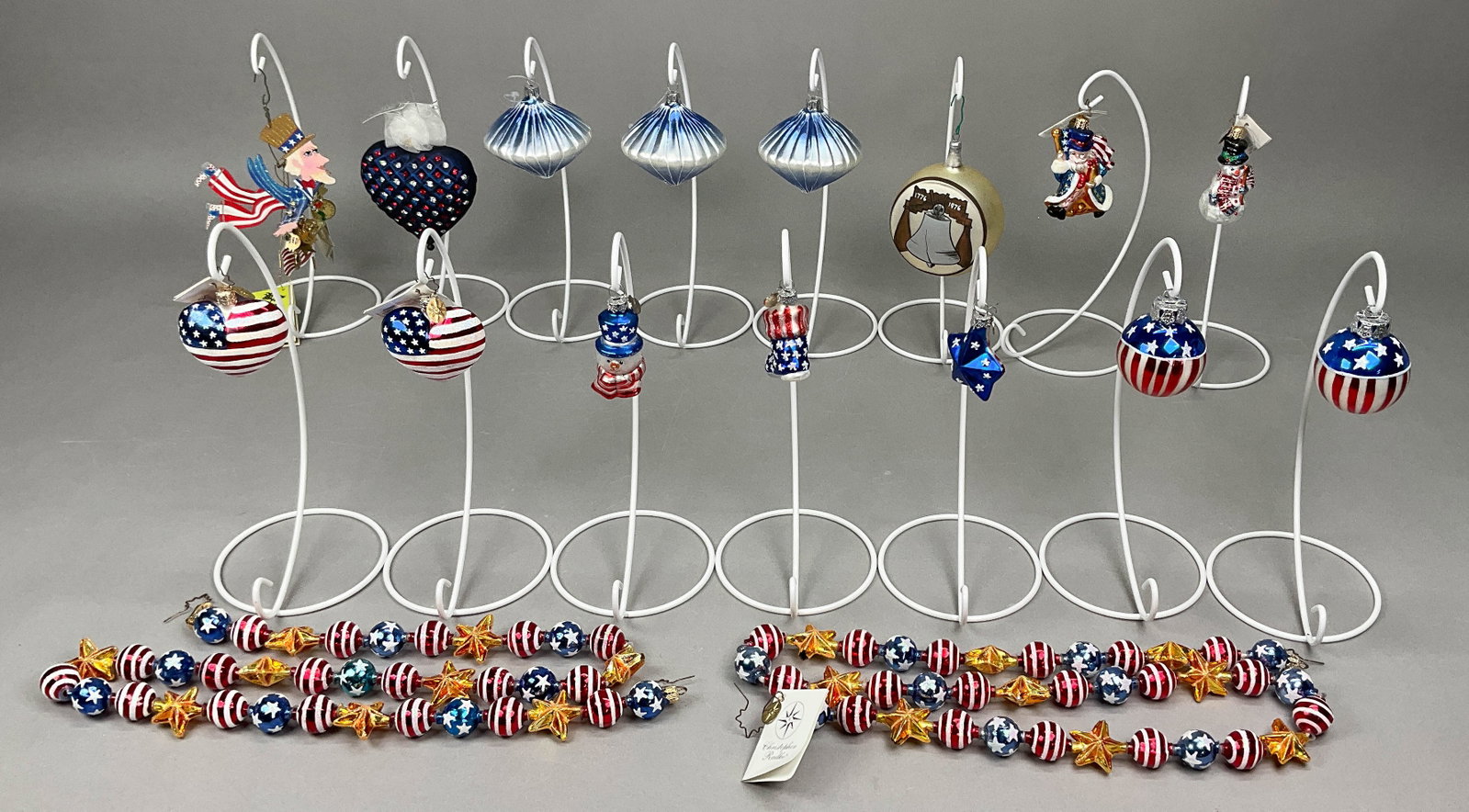 15 Patriotic Ornaments & 2 Garland Radko Silvestri: 15 Patriotic Ornaments & 2 Garland Radko Silvestri Swarovski, Vickerman - some with tags. Includes Vickerman Blue/Silver Ornaments (x3) - no tags, Silvestri Fanciful Flights, Swarovski Heart of a Pres