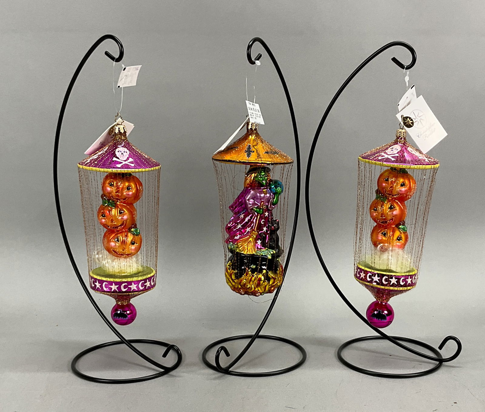 3 Radko Halloween Ornaments with Tags: 3 Radko Halloween Ornaments with Tags. Includes This Brews For you #1010253/10097 -- 8.5" & 2 Giggles n Grins #1010254/10098 - 10" long. Some loose stands of string on them. Some wear, loose strings a