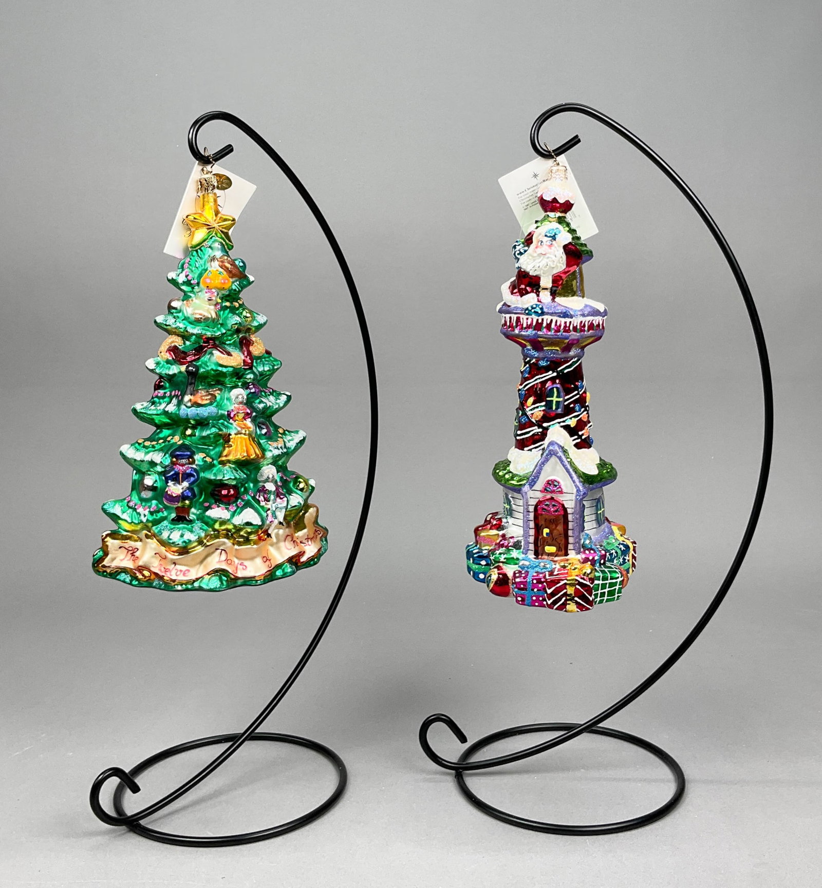 2 Radko Christmas Ornaments X-Large: 2 Radko Christmas Ornaments with Tags. Includes True Love's Tree #01-0106-0 - 9" long with loose hanger, Candy House Greetings #1010272 - 9.5" long.Some paint and glitter loss.Ornament stands are NOT 