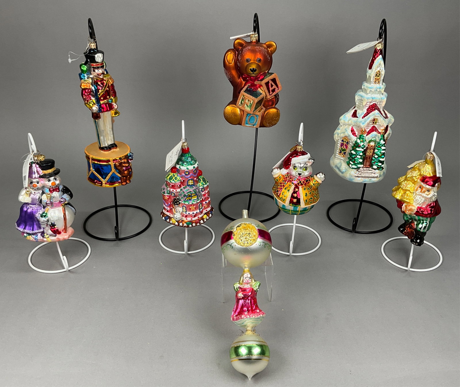 8 Radko Christmas Ornaments Most w/ Tags: 8 Radko Christmas Ornaments Most w/ Tags. Includes Candy Land Corner #99-HOU-3, Angels We Have Heard on High - Scratches throughout, and no gold tassels on ornament, some pink paint missing - no toppe