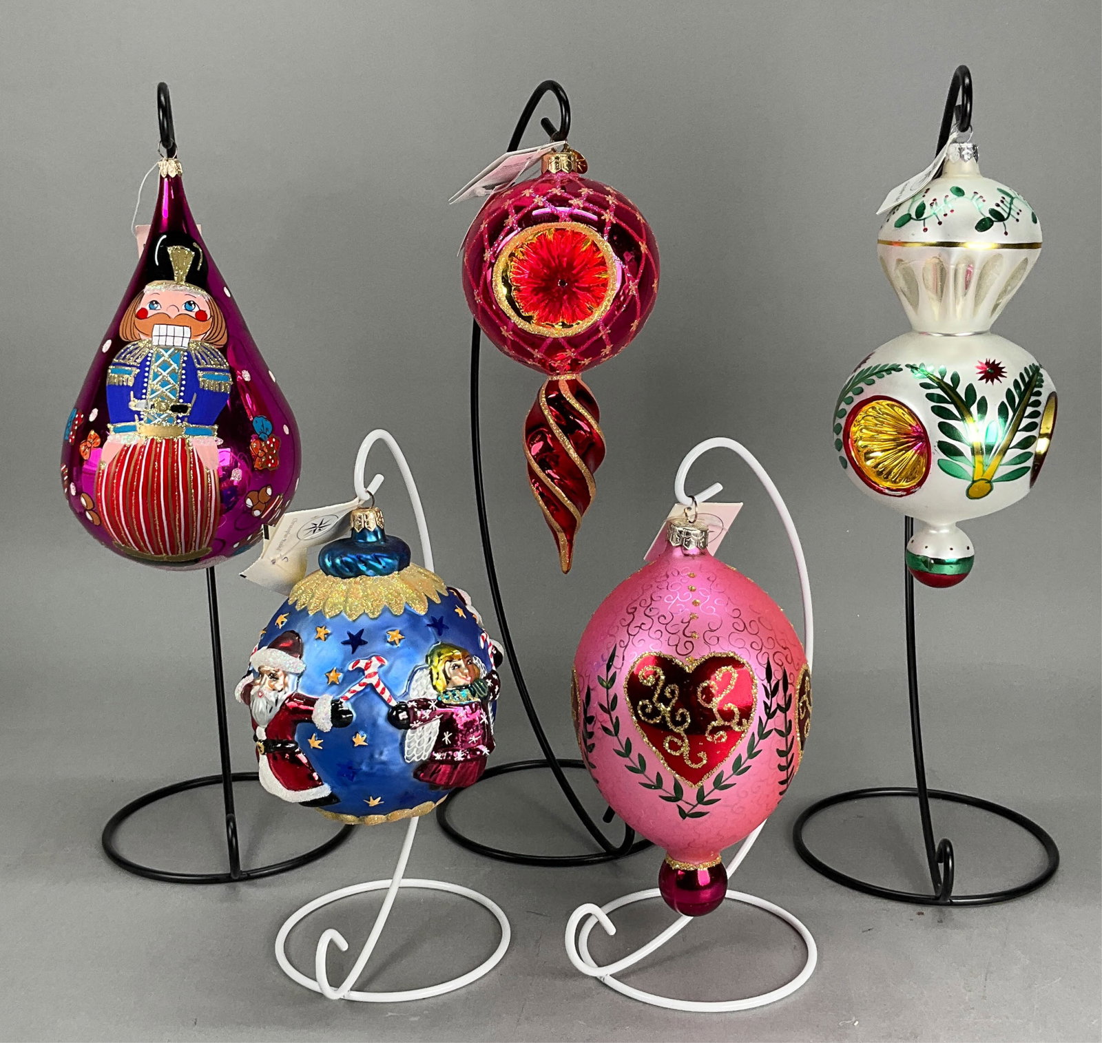 5 Radko Christmas Ornaments with Tags: 5 Radko Christmas Ornaments with Tags. Includes Triple Reflector Ornament - 8.25" - has some marks throughout the ornament, Star Reflection Red #003430 - 8.5" - Longest, Hearts Desire #962810, Nutcrac