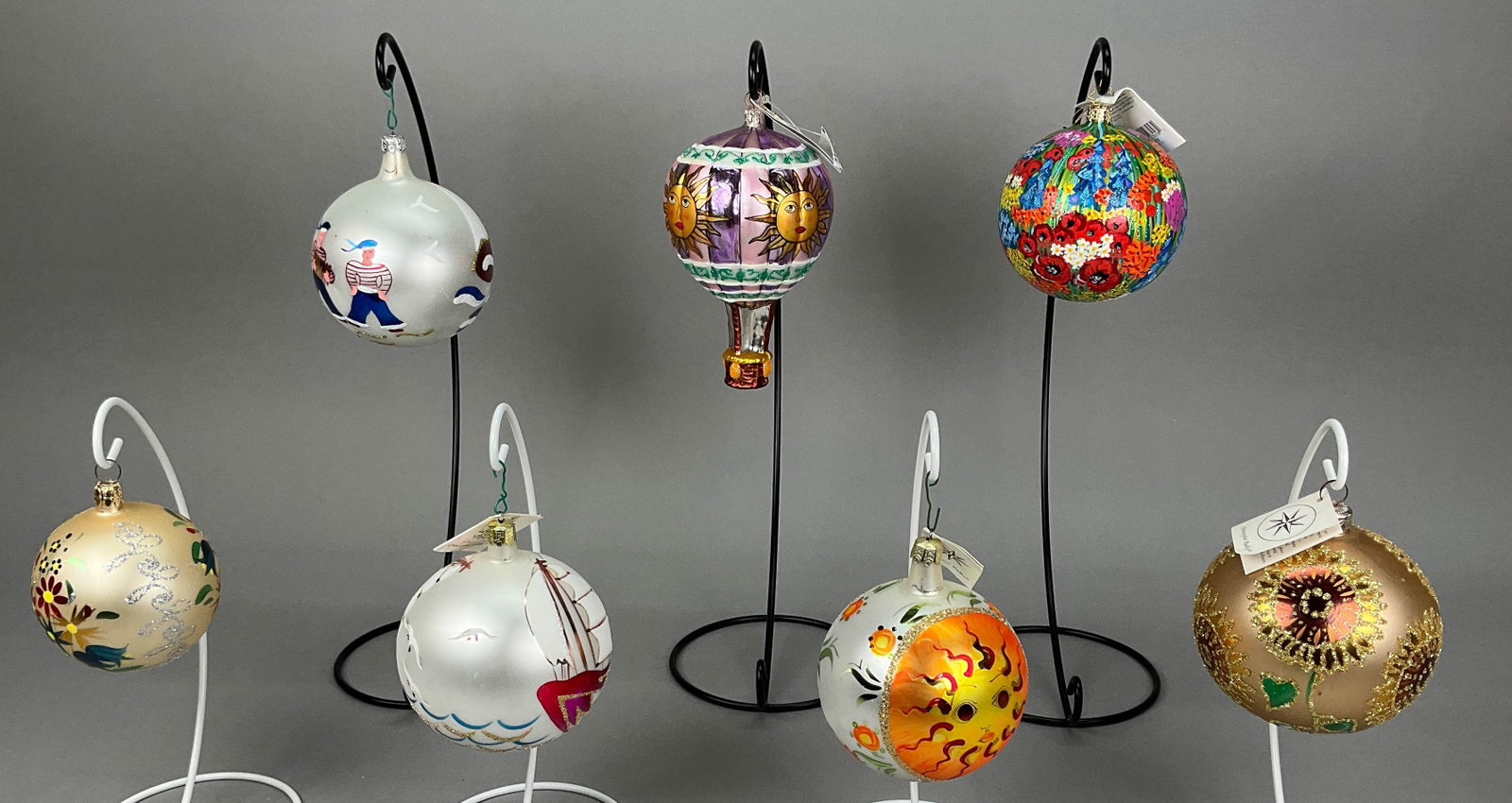 7 Radko Christmas Ball Ornaments Sunflower Sun: 7 Radko Christmas Ball Ornaments - Most with Tags. Includes Sunflower - has some spots on the base, Sailing the High Seas, 3 Sailors - Couple scratches, Sun and Flowers, Elysian Fields #10659, Flights