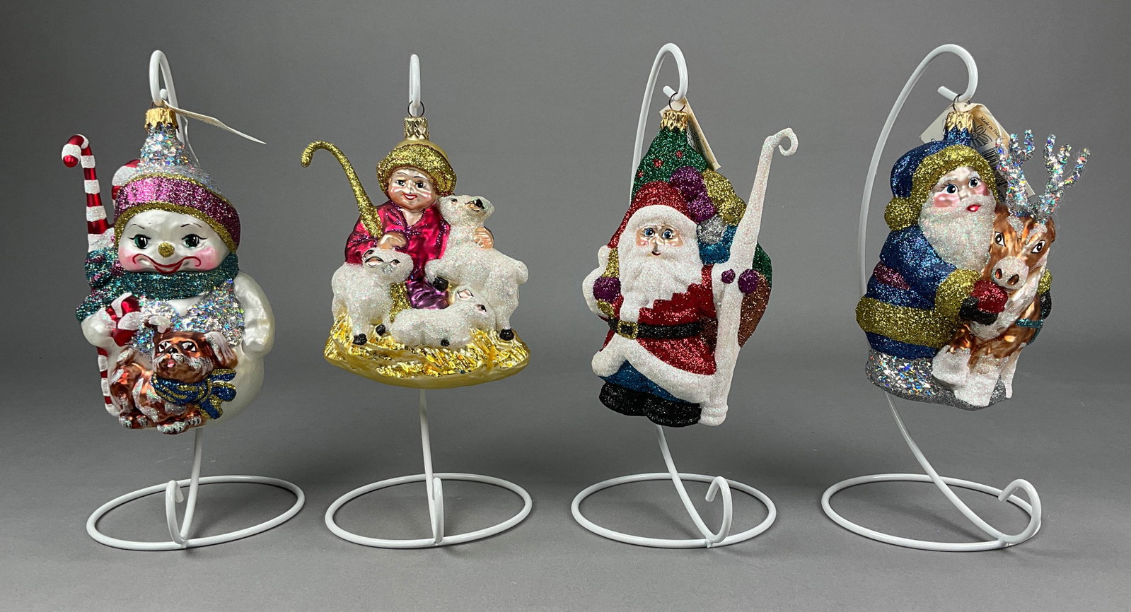 4 Fraga Christmas Ornaments Santa Shepard: 4 Fraga Christmas Ornaments Most with Tags. Includes Wispy Winds -- 6.5" - longest, Embracing Moment, Bag of Gifts Santa, Shepherd with his flock -- no tag -- 5" - Shortest. Scratches to bottom of She