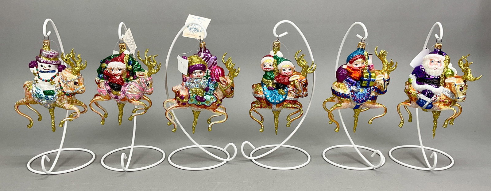 6 Fraga Santa's Reindeer Christmas Ornaments: 6 Fraga Santa's Reindeer Christmas Ornaments with Tags. Includes Dancer, Prancer, Vixen, Comet, Donner & Cupid (5.5"x4").Some paint and glitter loss.Ornament stands are NOT INCLUDED.The absence of a c