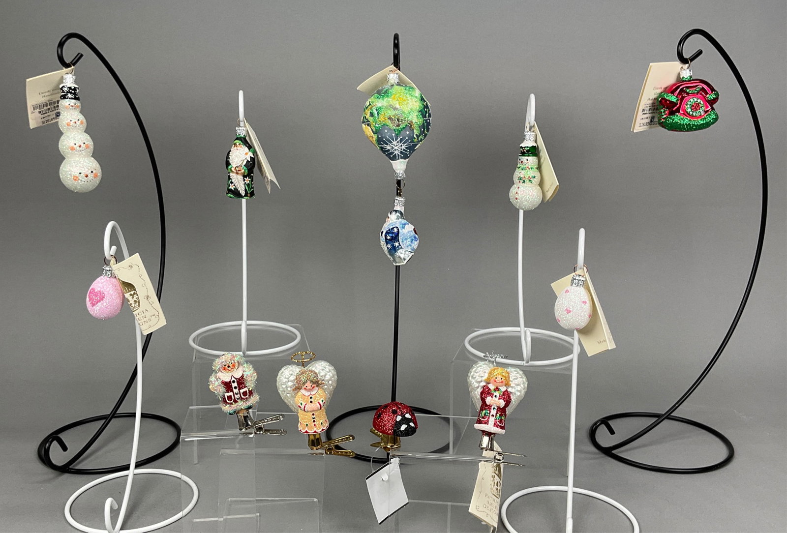 11 Breen Christmas Ornaments with Tags: 11 Breen Christmas Ornaments with Tags. Includes Hot Air Balloon Santa -- 6.5" - Longest, Snowmen, White and pink Egg Ornaments - 2" - Shortest, Angel with Gold Robe and bottom clip - no tag, angel in