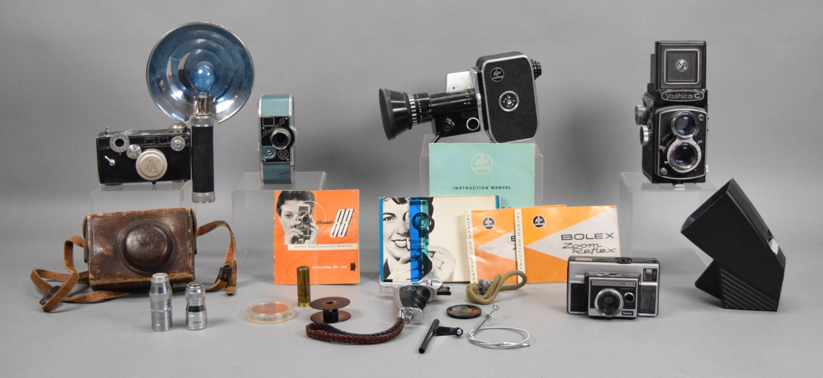 Lot of Cameras & Accessories Yashica, Argus, Bolex: Lot of vintage cameras and accessories, including 2 movie cameras: Bauer 88 8mm with manual, Bolex Paillard with manuals and pistol grip; Kodak Instamatic 314, Argus C3 "brick" camera with Argus Cinta