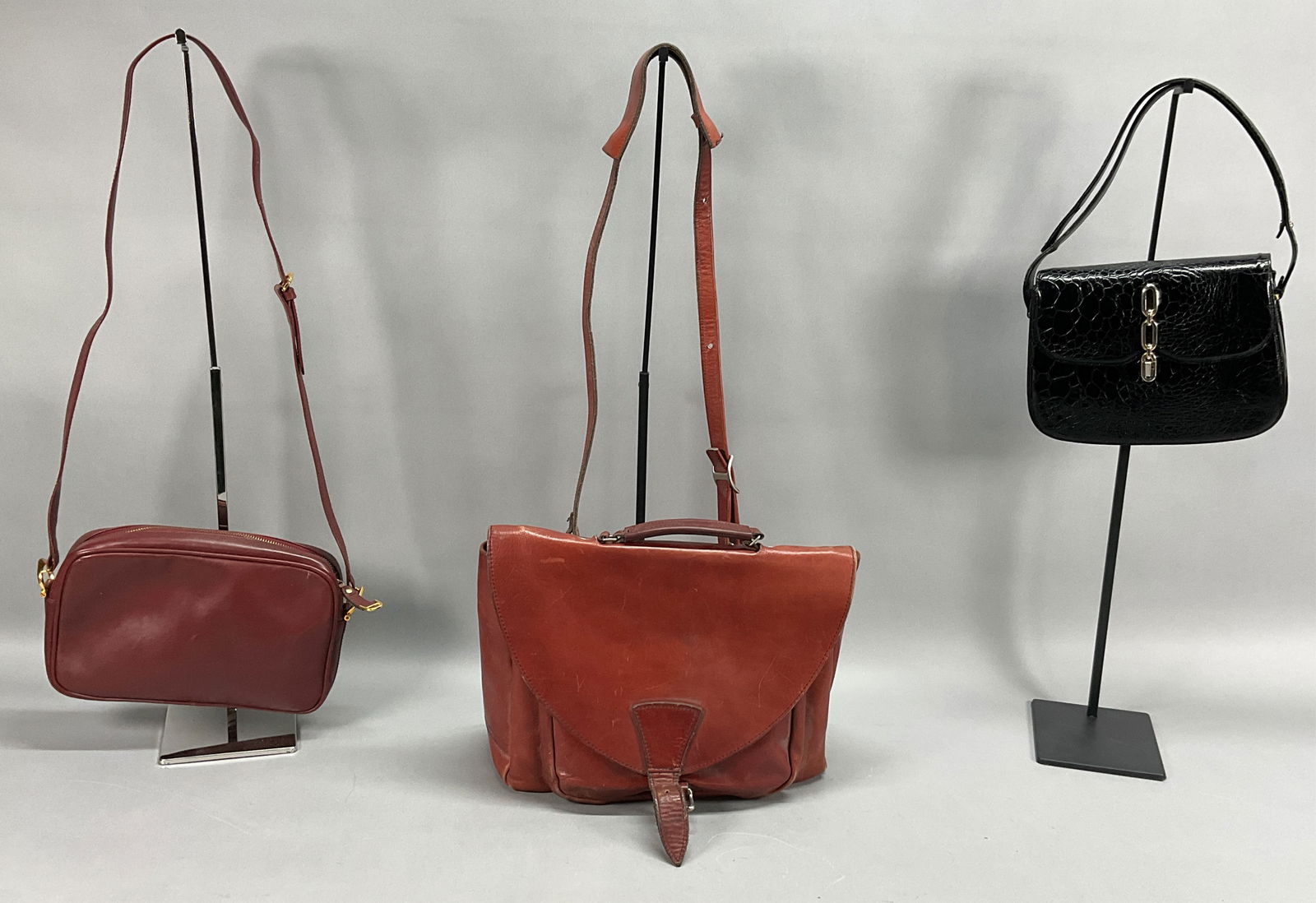 3 Leather Bags - Purses - Satchel - Cartier, Eisen: 3 Leather Bags - Purses and Satchel. Burgundy Cartier purse 11.5" x 7", wear to the edges and corners, marks on the bag. Large bag is Fred Eisen Designs 13" x 11" large bag interior with 2 sections an