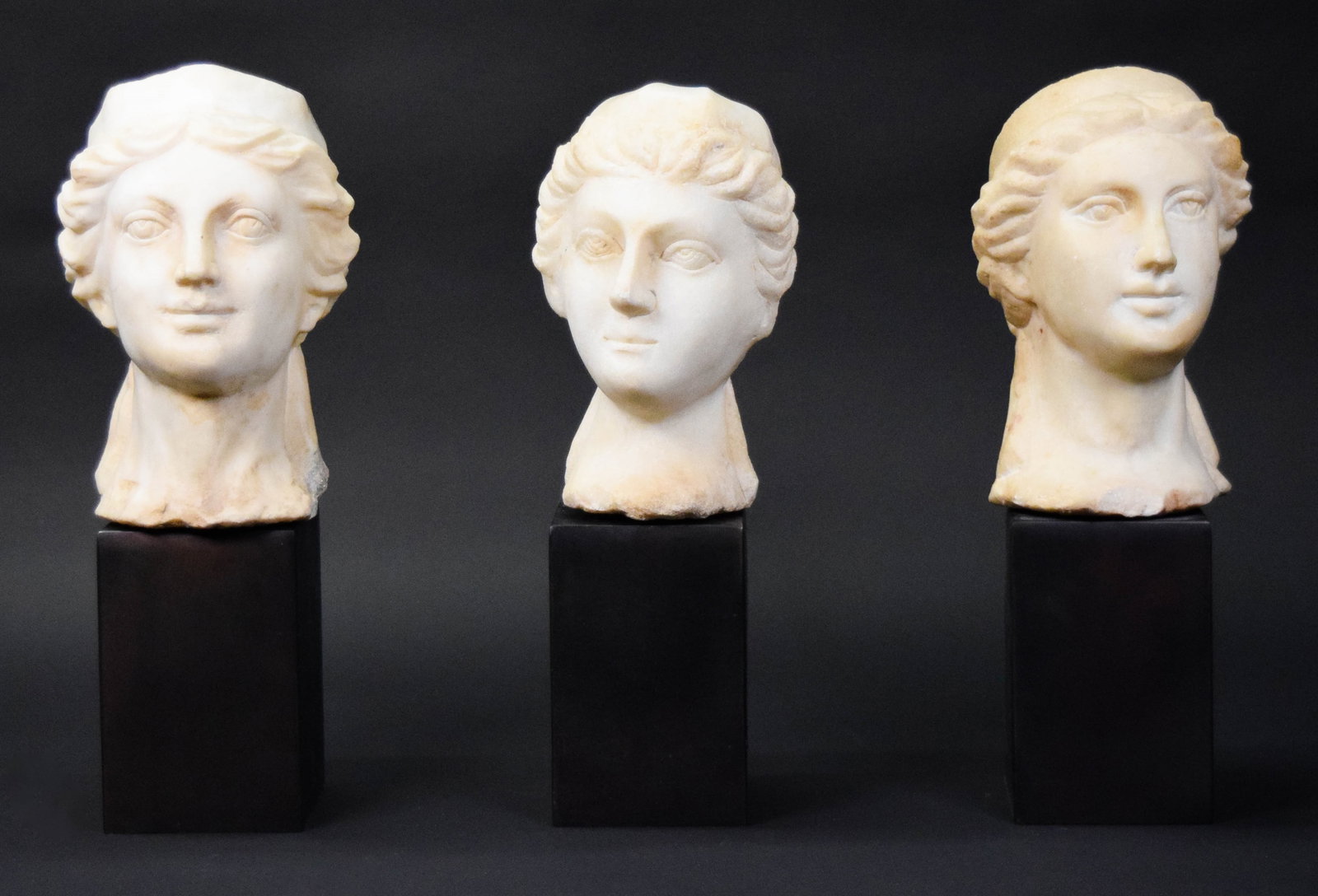 3 Carved Alabaster Heads of a Woman: 3 carved alabaster heads of a woman. Each on metal pedestal base. All unsigned. Largest 8 1/2"H (with base 14"H). All with chips and some discoloration, bases all with scratches. From the estate of Eg