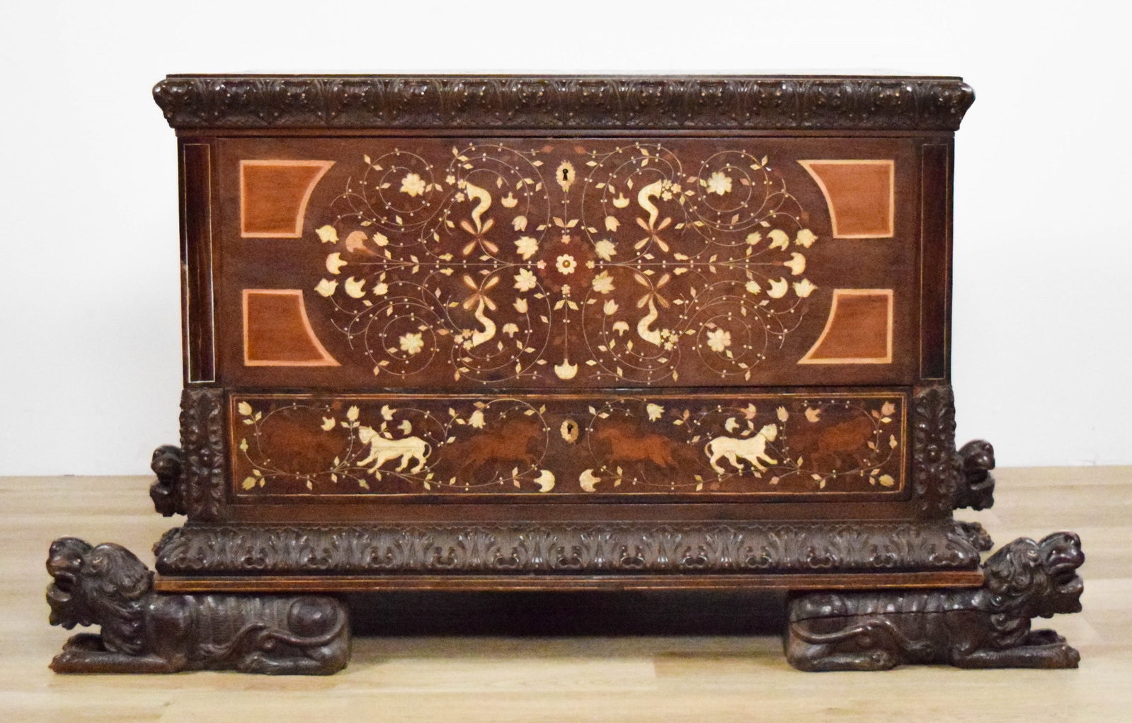 Carved & Inlaid Teak Chest: Carved teakwood chest, with bone and wood inlays of animals and flowers, figural foo dog feet. With one drawer. 52 1/2"L x 26 3/4"W x 30 3/8"H. (without feet 42 1/4"L x 25 1/2"W x 26 1/4"H). Splits to