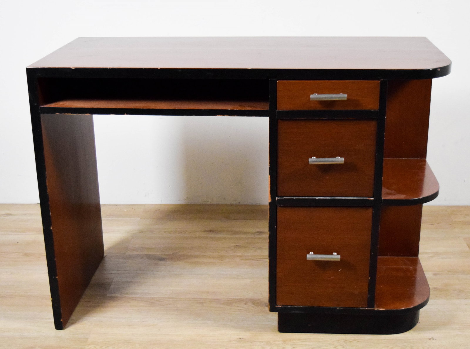 Art Deco Desk: Art deco desk. 43"L x 19 1/8"D x 30 1/2"H. Scratches, chips and sections of veneer missing throughout, large scratch across top, split from top down one side, draws do not close evenly.