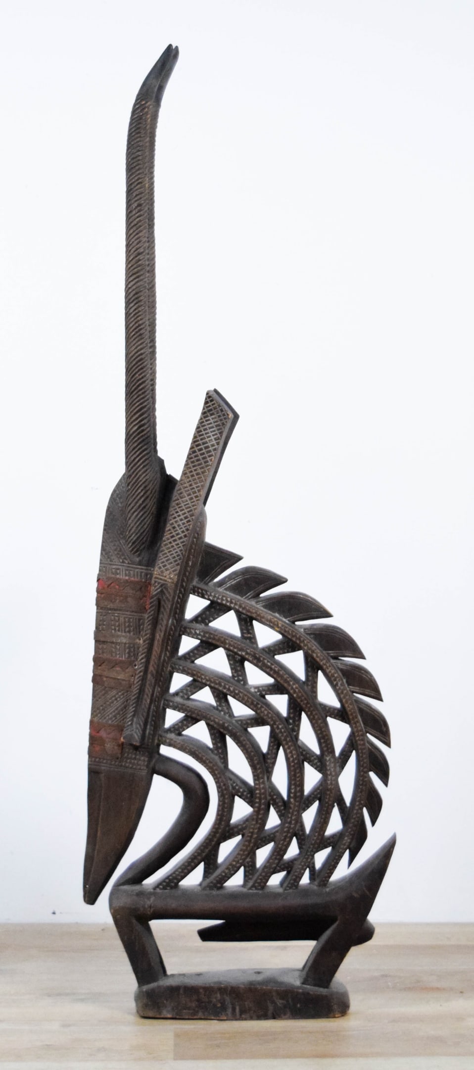African Bamana Wood Carved Chiwara Headdress Mali: African Chiwara antelope headdress, carved wood with metalwork and fabric, Bamana, Mali. 56 3/4"H. Minor chips, splits and losses throughout, larger chip to one point along the back. Provenance: Estat