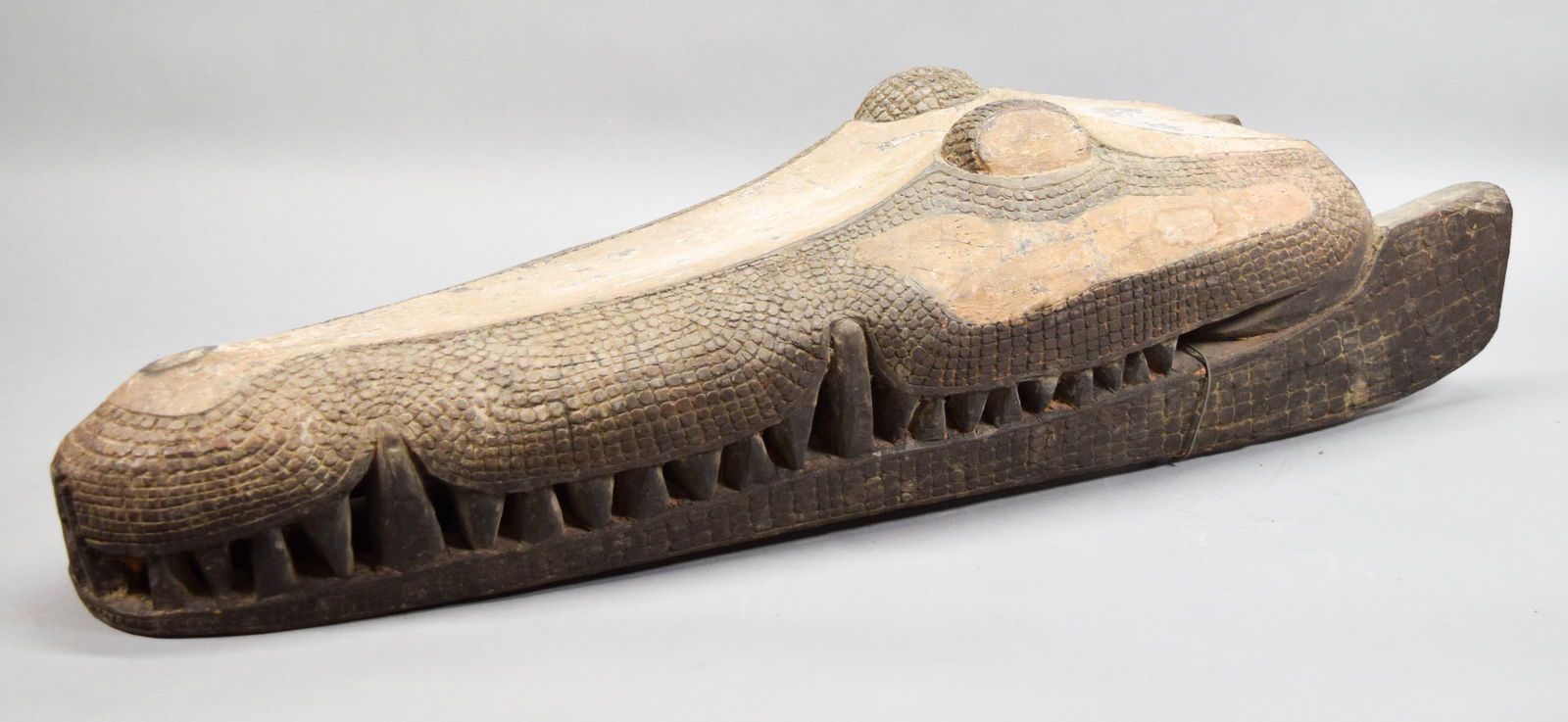 Carved Wood Crocodile Canoe Prow Papua New Guinea: Wood carved crocodile form canoe prow, probably Sepik River region, Papua New Guinea. 41"L x 12"W x 10 1/4"H. Chips and splits throughout, one front tooth missing. Provenance: Estate of Princess Maria