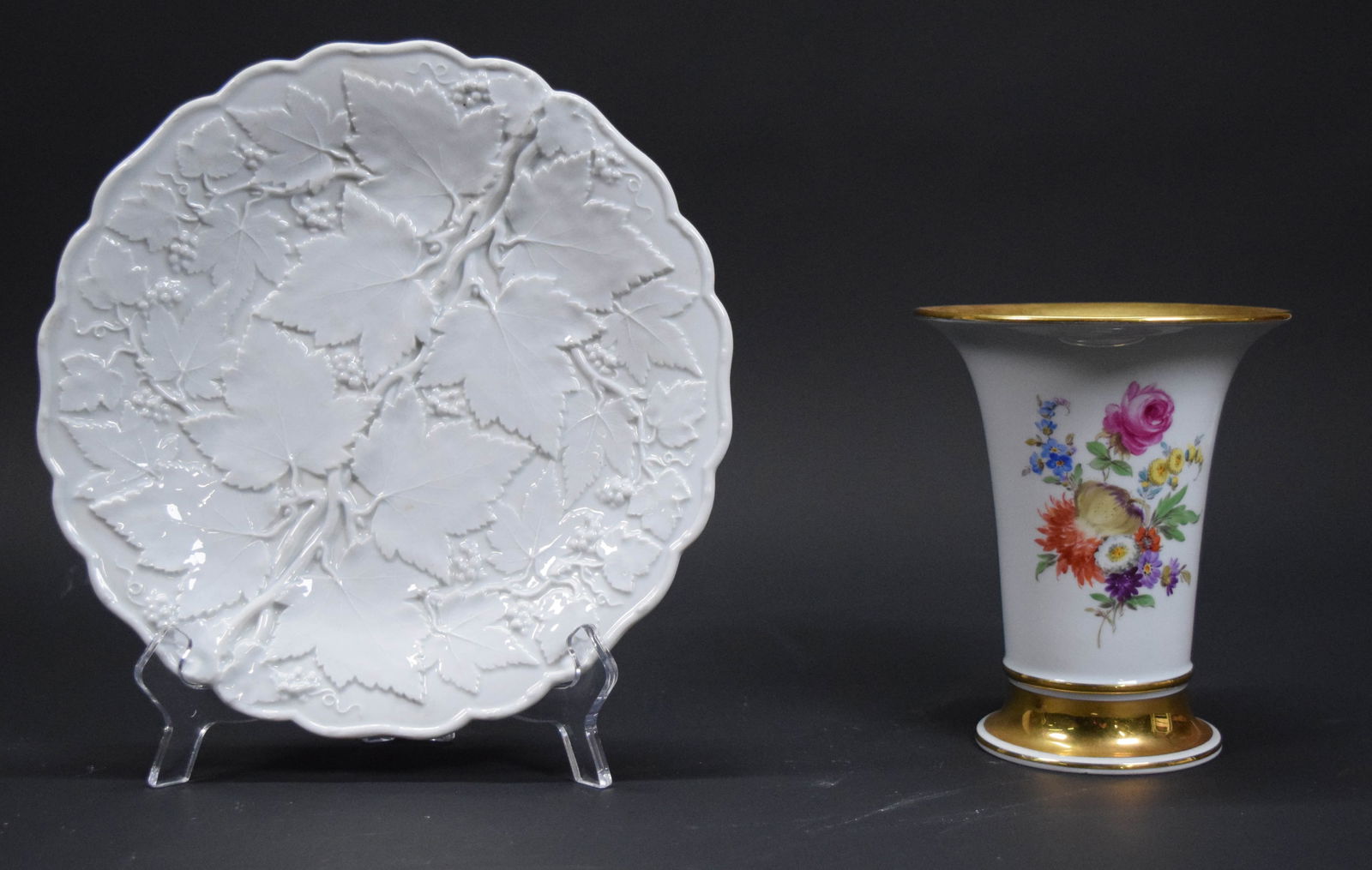2 Pieces Meissen Porcelain Vase & Plate: 2 pieces Meissen German porcelain. Maple leaf plate, 9 7/8"-diameter; vase with floral motif, 6 1/2"H. Both with blue Meissen crossed swords marks to the undersides. Plate with firing and glaze imperf