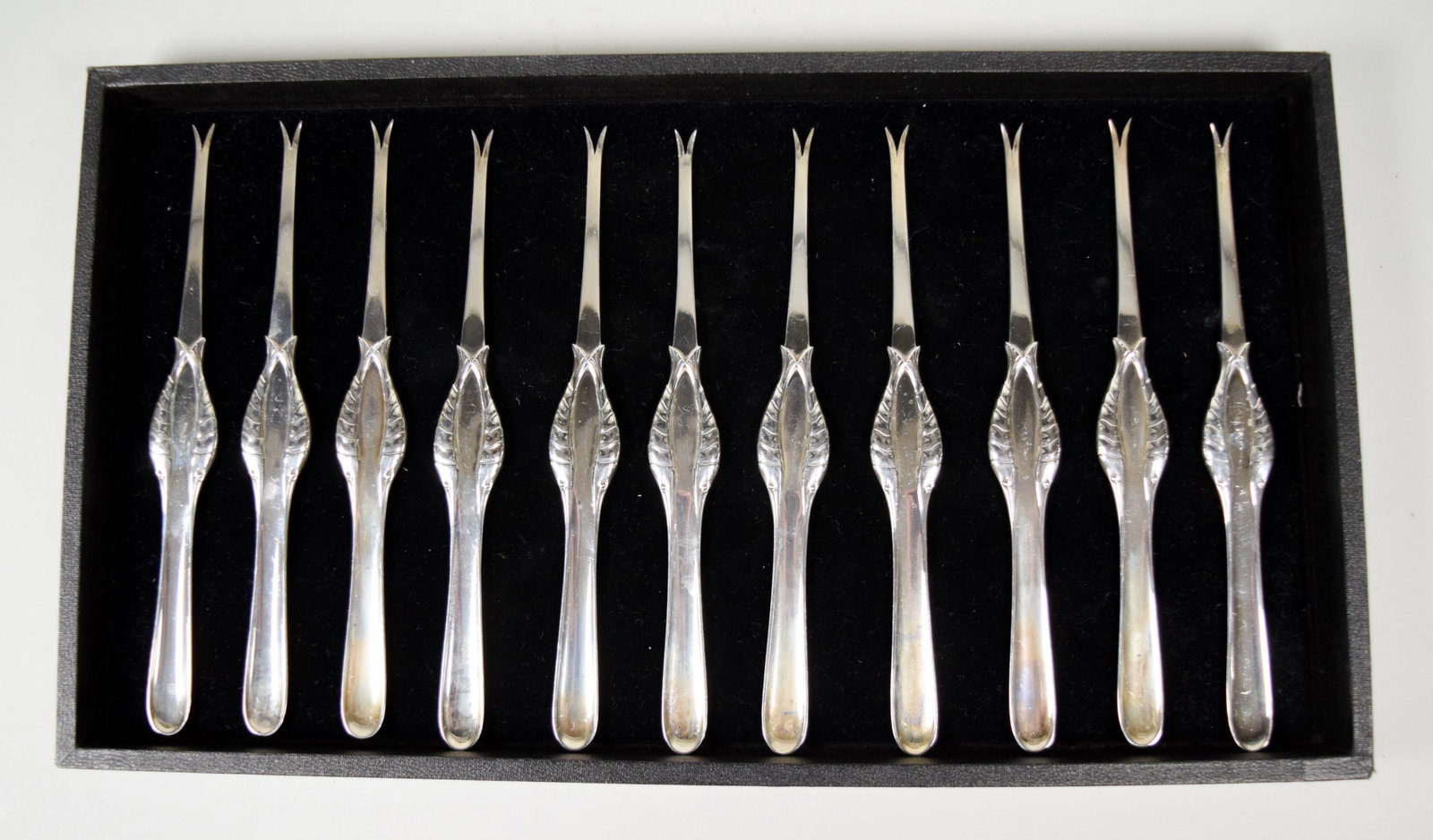 11 Georg Jensen Sterling Lobster Picks: Set of 11 Georg Jensen figural sterling silver lobster picks. Each signed Denmark Sterling with Jensen mark circa 1910-1925. Each 7 3/8"L. 425.8 grams total.Provenance: The estate of Fred Leighton, Ne
