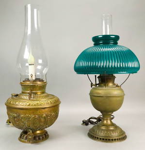 2 Brass Kerosene Lamps Juno, B&H: 2 brass kerosene lamps. Both electrified. Juno lamp, with chimney, no shade, lamp with chimney 21 1/2"H; Bradley & Hubbard, with chimney and green ribbed cased glass shade, lamp 20 1/4" to top of