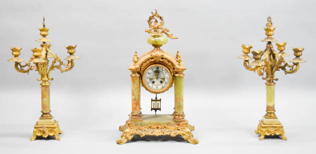 3 Piece Gilbert Onyx Clock Set: 3 piece garniture set, green onyx and gilt metal, with a Gilbert mantel clock and a pair of associated 5 light candelabra. Clock with outside escapement, marked Gilbert Clock Co., Winstead Conn. USA a