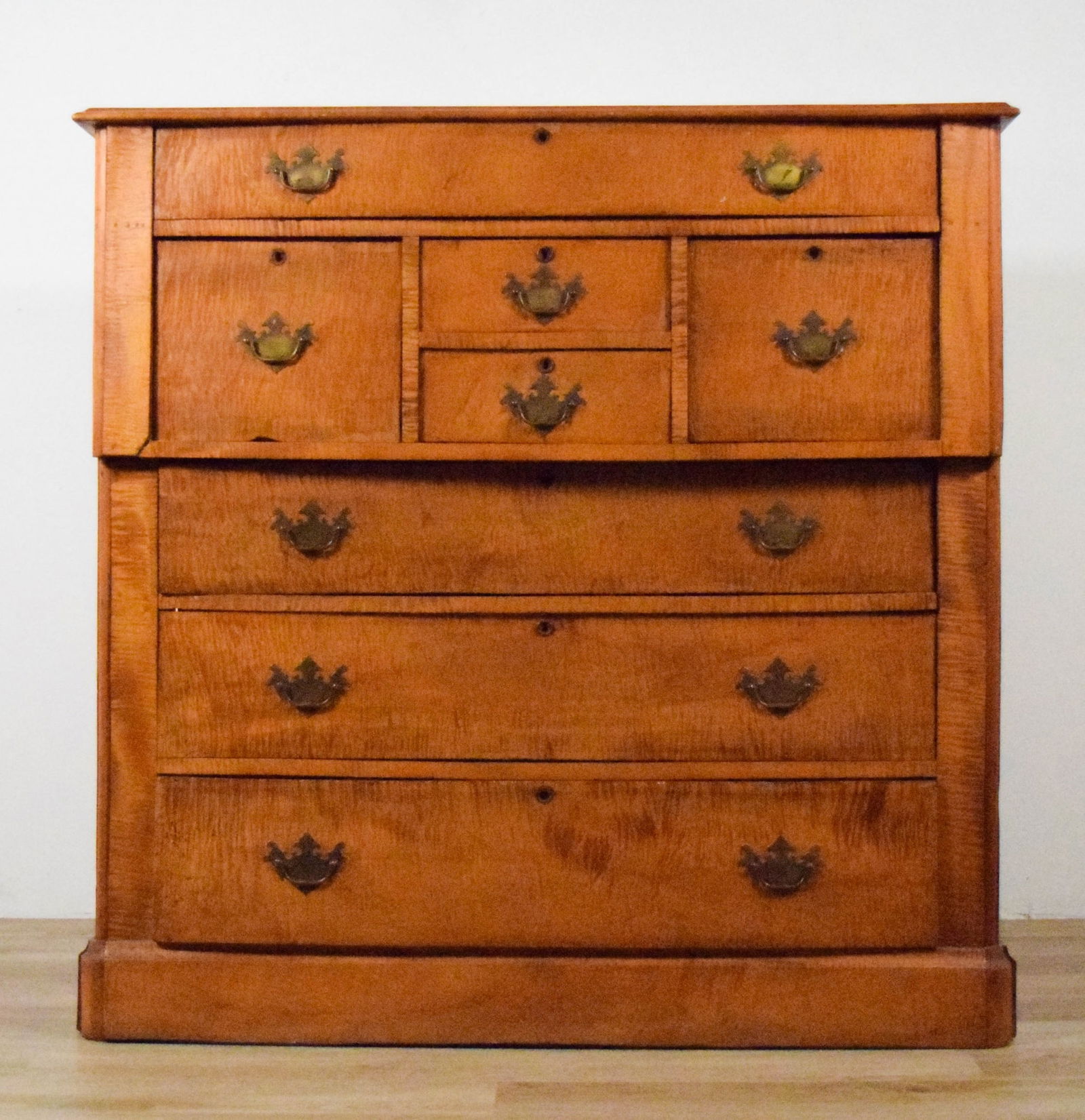 Tiger Maple Bachelor's Chest: Tiger maple bachelor's chest, 19th century. 49 5/8"W x 21 1/8"D x 49 1/4"H. Chips, scratches and splits to wood throughout, back panels loose, some separating at sides, drawers warped and do no close