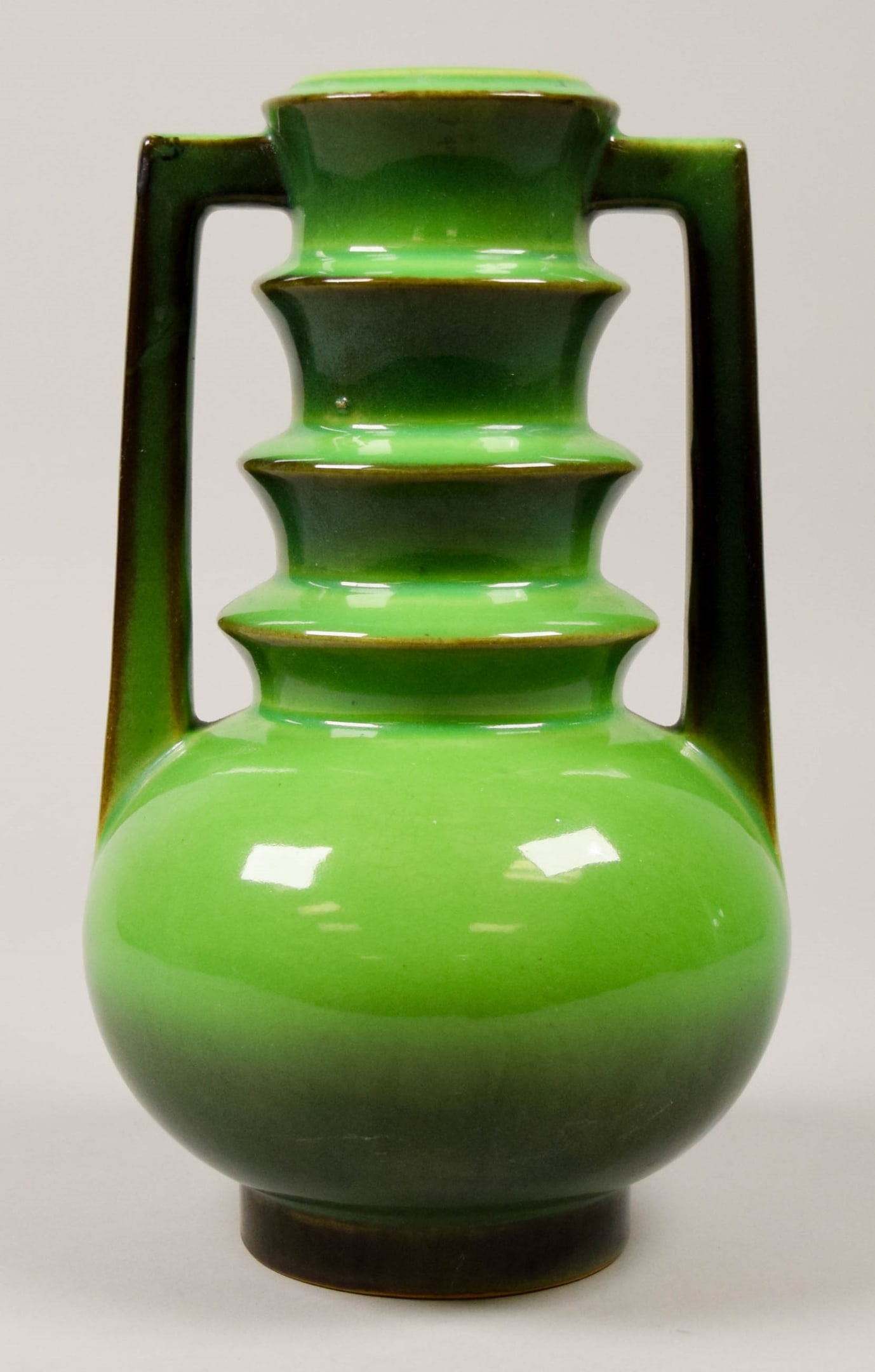 Roseville Pottery Futura Vase Emerald Urn: Roseville Pottery Futura "Emerald Urn" vase. Roseville Pottery paper label on the underside. 9"H.Provenance: The Estate of Dr. Benard Dreyer. Dr. Benard Dreyer, past president of the American Academy