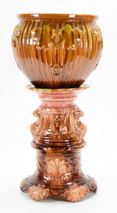 Majolica Jardiniere & Pedestal Weller & JB Owens: Majolica pottery jardiniere and pedestal. Weller jardiniere, with leaf motif, unsigned, 10"H x 11 1/2"-diameter at top; J.B. Owens pedestal, with griffins, unmarked, 15 1/4"H. Jardiniere and pedestal
