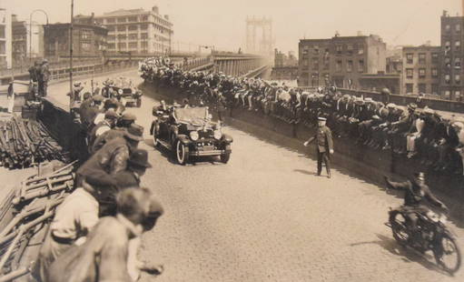 Charles Lindbergh Parade Photograph: Photograph, Charles Lindbergh entering Brooklyn from Manhattan Bridge, 1927. Unsigned. Matted, unframed. Cityana label with info on verso. 8 1/4" x 13 1/4" (with mat 14" x 18"). Staining and discolora