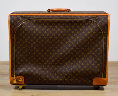 Louis Vuitton Vintage Luggage Monogram Suitcase: Vintage Louis Vuitton monogram leather suitcase, with zipper lock and wheels. Marked Louis Vuitton Malletier on one corner. 28 3/4"W x 9 1/2"D x 21 3/4"H (with wheels 23 1/2"H). Fraying to stitching a