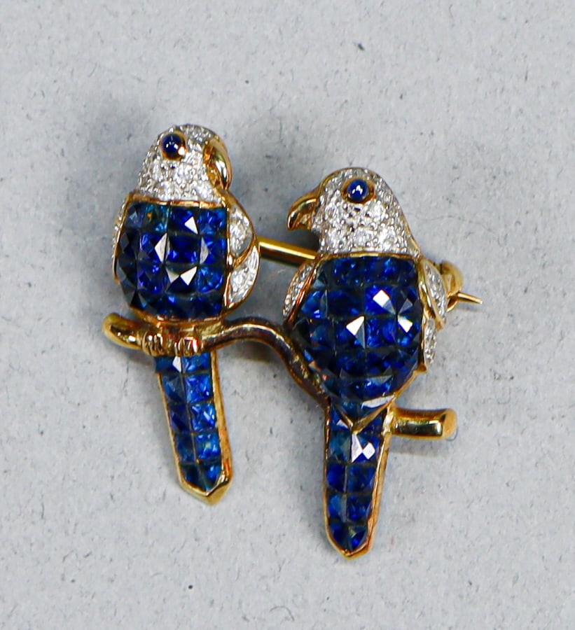 Sapphire And Diamond 18 K Gold Lovebird Brooch: Lovebird brooch with sapphire and diamonds mounted in 18K gold. Marked "750". 1" Tall x 3/4" Wide 4.7 grams total weight.