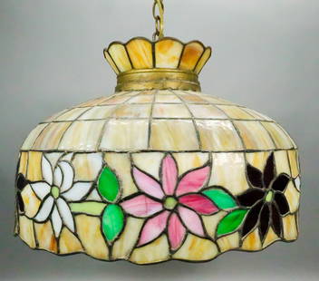 Tiffany Style Leaded Hanging Fixture: Tiffany style leaded slag glass hanging light fixture. Caramel slag glass, with floral motif in various colors. Unsigned. 12 1/2"H x 20 1/8"-diameter. Cracks throughout, repairs to leading throughout.