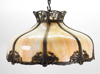 Slag Glass Hanging Fixture: Slag glass hanging light fixture. Metal overlay, caramel slag glass. Unsigned. 12"H x 21 5/8"-diameter. Missing socket wiring. Crack to metal along rim.
